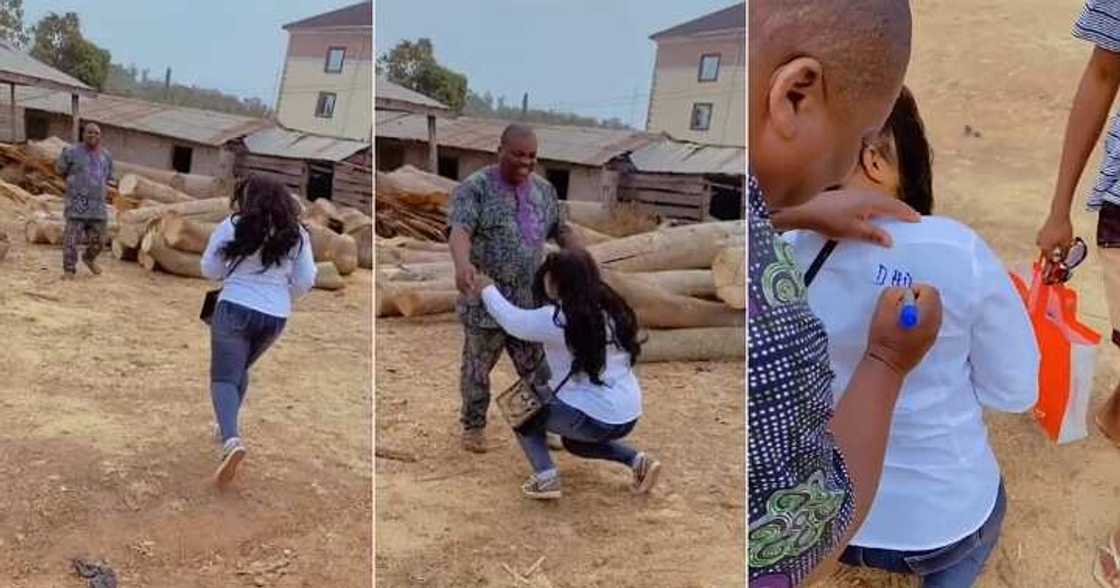 Female graduate kneels before dad, sign out on shirt, appreciation Female graduate kneels before dad, sign out on shirt, appreciation