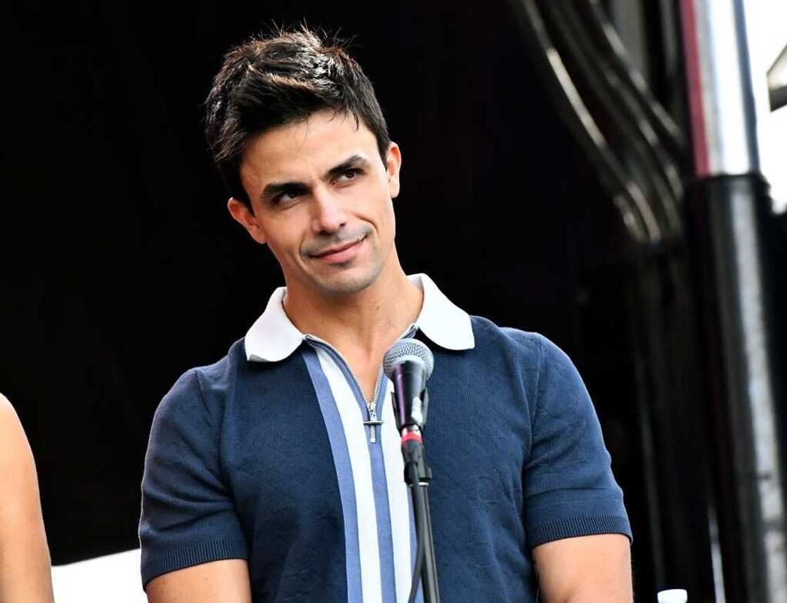 Gio Helou appears onstage in a navy blue and white shirt Gio Helou appears onstage in a navy blue and white shirt