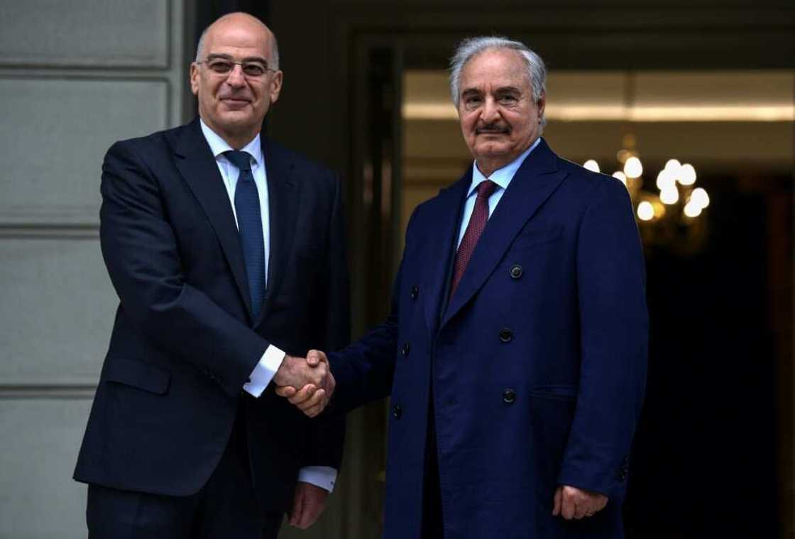 Greece has long favoured Libya's eastern strongman Khalifa Haftar (R) in his power struggle with the Turkish-backed government in the capital Tripoli Greece has long favoured Libya's eastern strongman Khalifa Haftar (R) in his power struggle with the Turkish-backed government in the capital Tripoli
