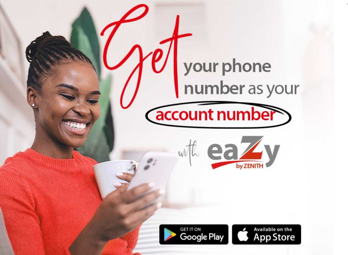 A customer using the Zenith Bank app while holding a cup A customer using the Zenith Bank app while holding a cup