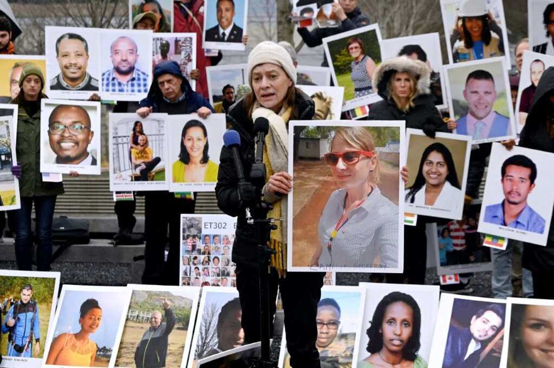 Families of victims of the March 10, 2019, crash of a Boeing 737 MAX airplane in Ethiopia hold up photos of the dead during a protest in Arlington, Virginia Families of victims of the March 10, 2019, crash of a Boeing 737 MAX airplane in Ethiopia hold up photos of the dead during a protest in Arlington, Virginia