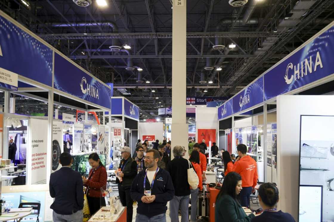 Attendees walk past a row of Chinese businesses at the annual Las Vegas tech show CES in January, 2024