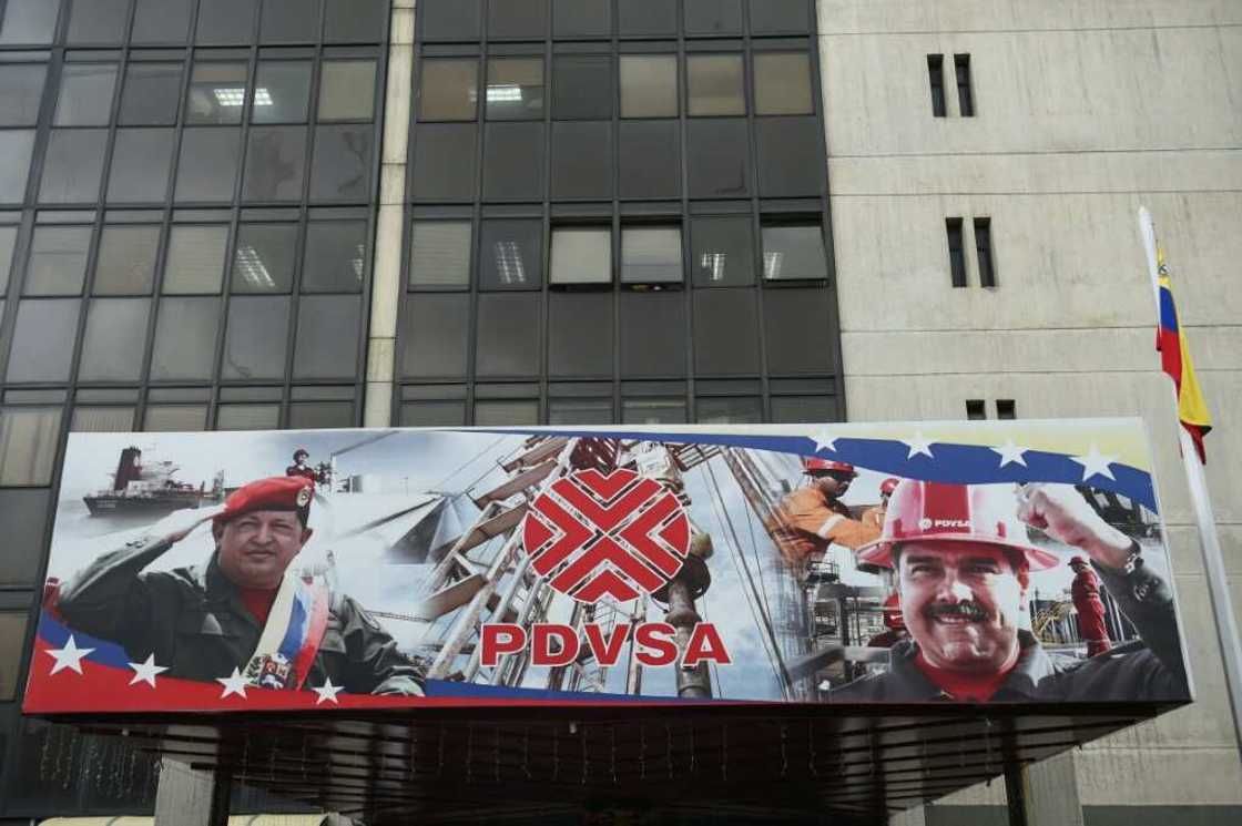 An entrance to the headquarters of Venezuela's state oil giant, known as PDVSA, displays portraits of late Venezuelan President Hugo Chavez (L) and current President Nicolas Maduro (R) An entrance to the headquarters of Venezuela's state oil giant, known as PDVSA, displays portraits of late Venezuelan President Hugo Chavez (L) and current President Nicolas Maduro (R)