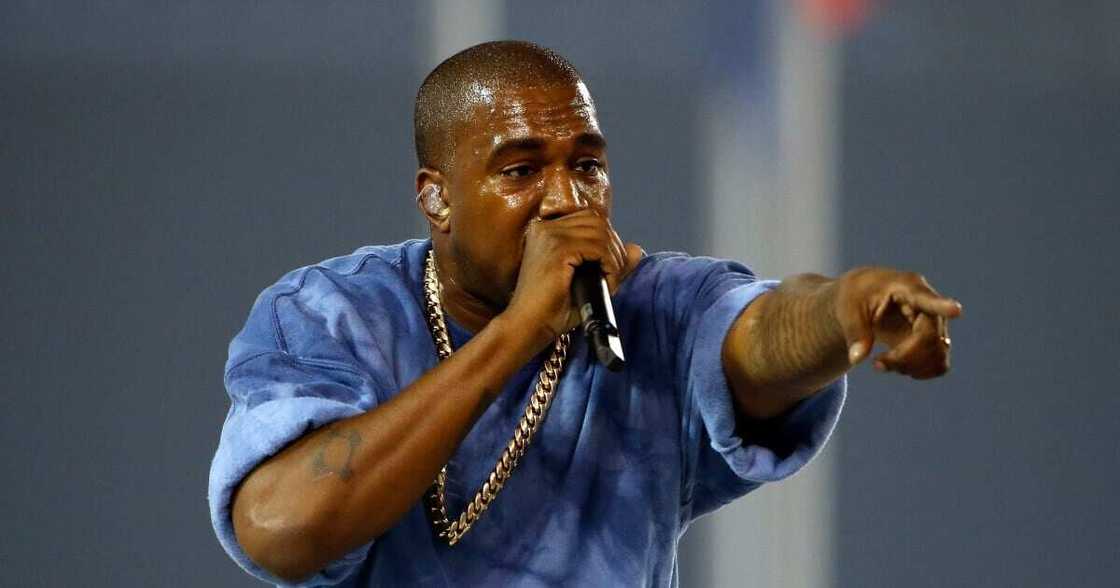 A photo of Kanye West at a show. A photo of Kanye West at a show.