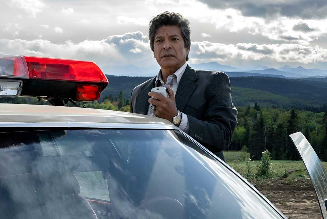 Gil Birmingham as Detective Bill Taba speaks through a radio receiver Gil Birmingham as Detective Bill Taba speaks through a radio receiver