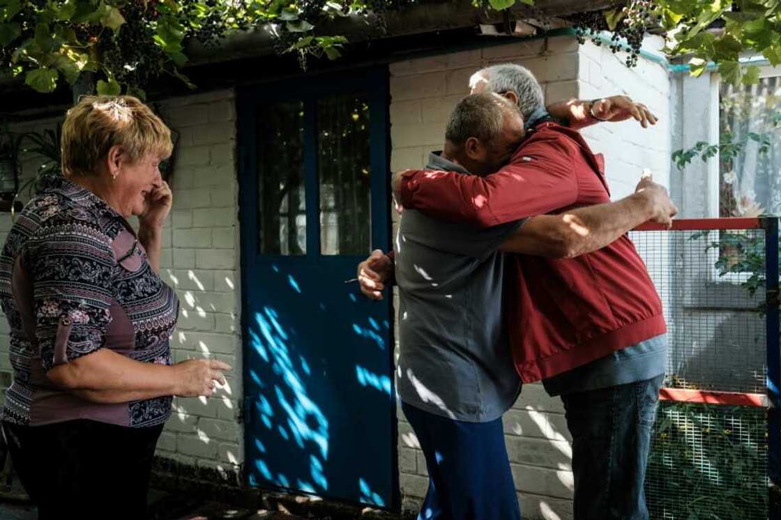 Ukrainians in the eastern village of Troitske reunite after the area was recaptured following a months-long occupation by Russia's army Ukrainians in the eastern village of Troitske reunite after the area was recaptured following a months-long occupation by Russia's army