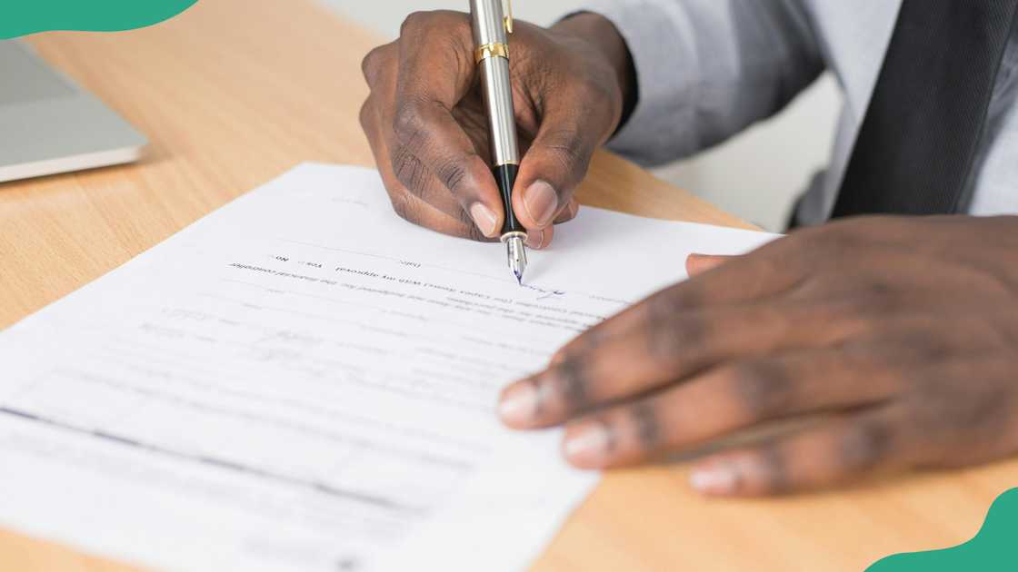 Someone writing on a piece of paper