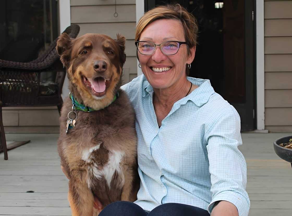 Paula Mae Ciccone poses sitting with her dog