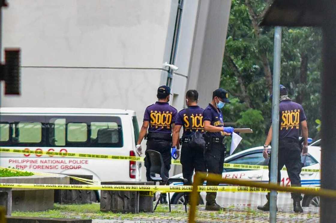 Police recovered two handguns and a silencer allegedly used by the suspect Police recovered two handguns and a silencer allegedly used by the suspect