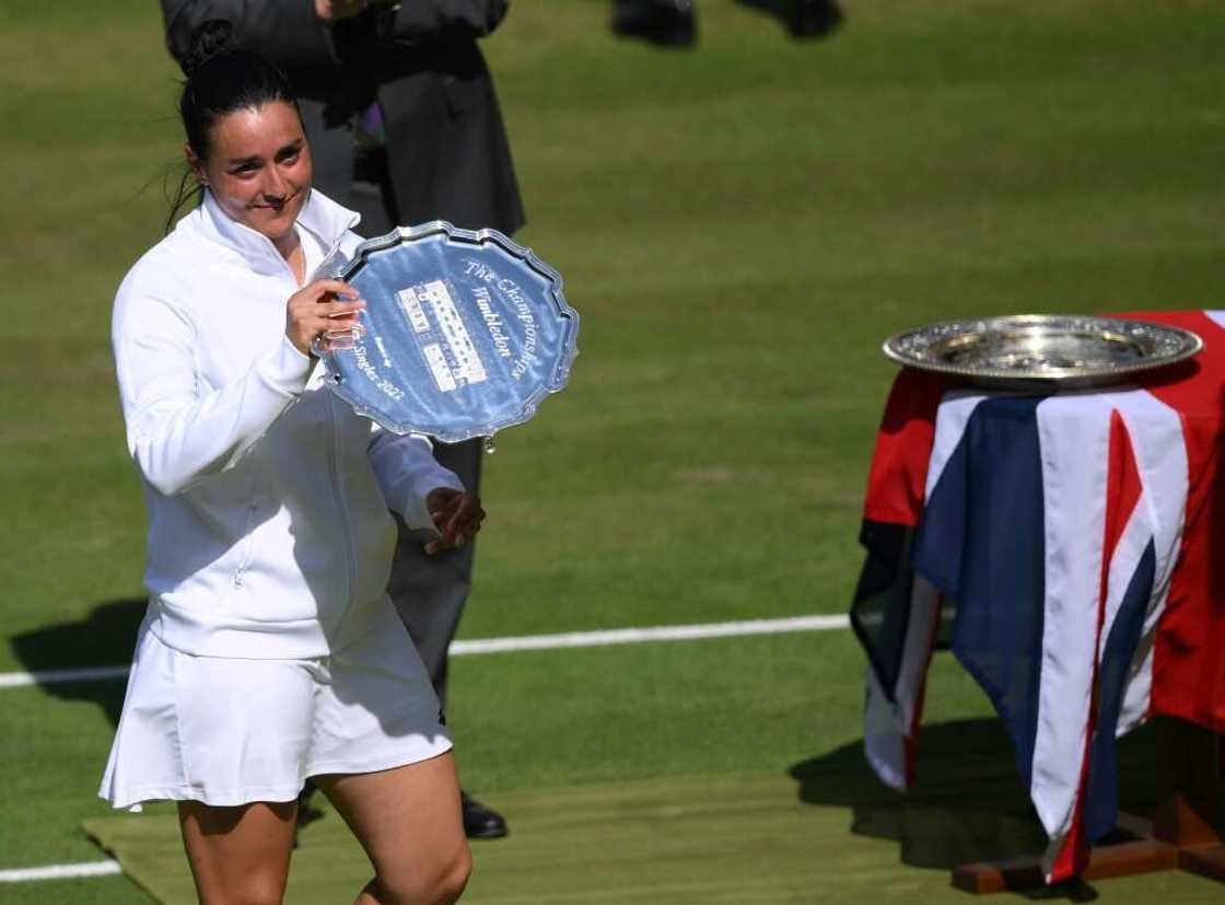 Tunisia's Ons Jabeur celebrates shows her runner-up trophy during the podium ceremony after losing against Kazakhstan's Elena Rybakina in their women's singles final at Wimbledon Tunisia's Ons Jabeur celebrates shows her runner-up trophy during the podium ceremony after losing against Kazakhstan's Elena Rybakina in their women's singles final at Wimbledon