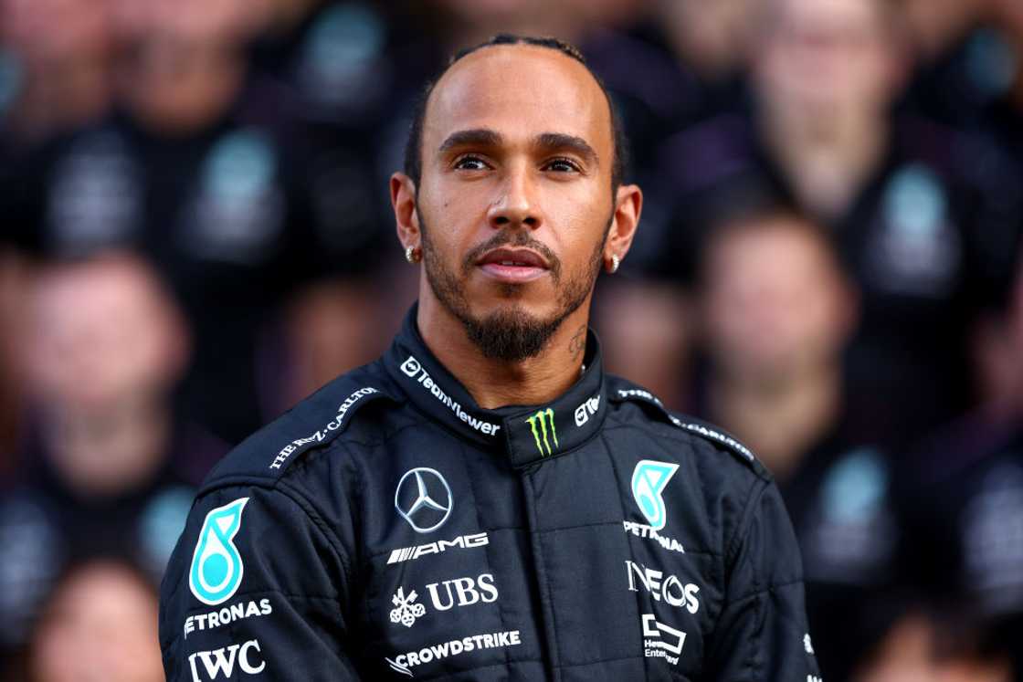 Lewis Hamilton looks on at the Mercedes GP Team Photo during previews ahead of the F1 Grand Prix of Abu Dhabi Lewis Hamilton looks on at the Mercedes GP Team Photo during previews ahead of the F1 Grand Prix of Abu Dhabi