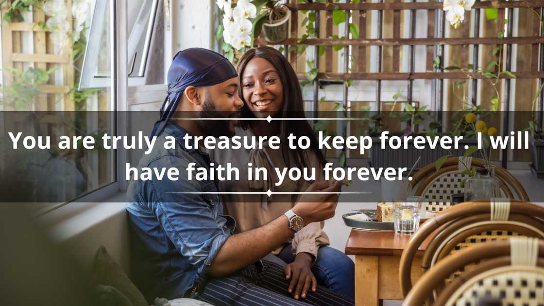 A young, affectionate African couple sit at a coffee shop. A young, affectionate African couple sit at a coffee shop.