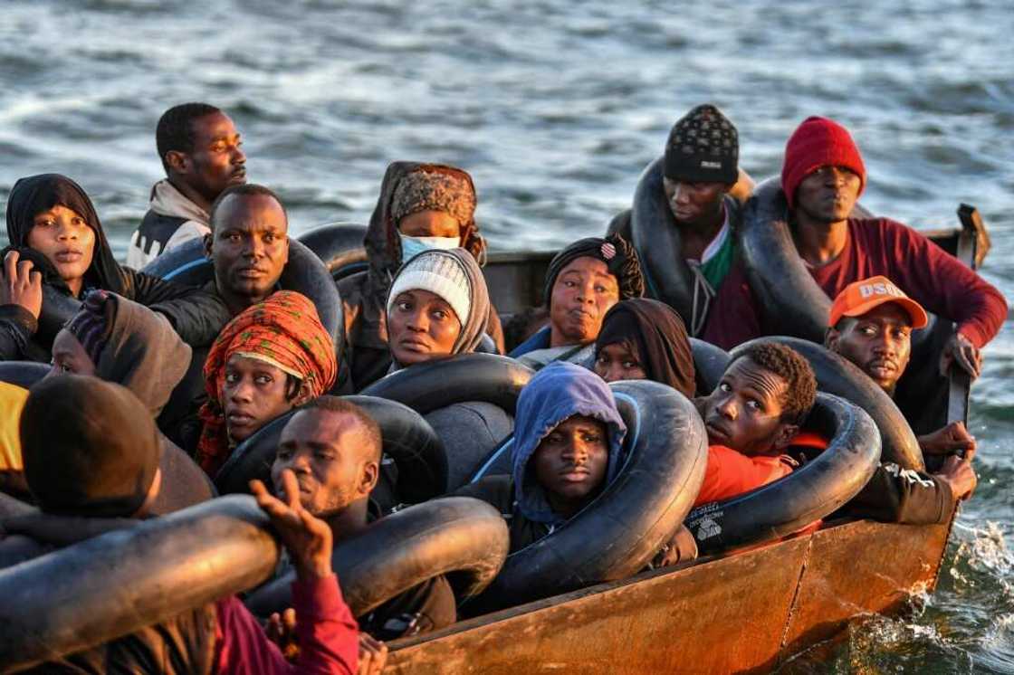 Migrants from sub-Saharan Africa stare dejectedly at Tunisian coastguards as they are intercepted in a barely seaworthy vessel 50 nautical miles out into the Mediterranean