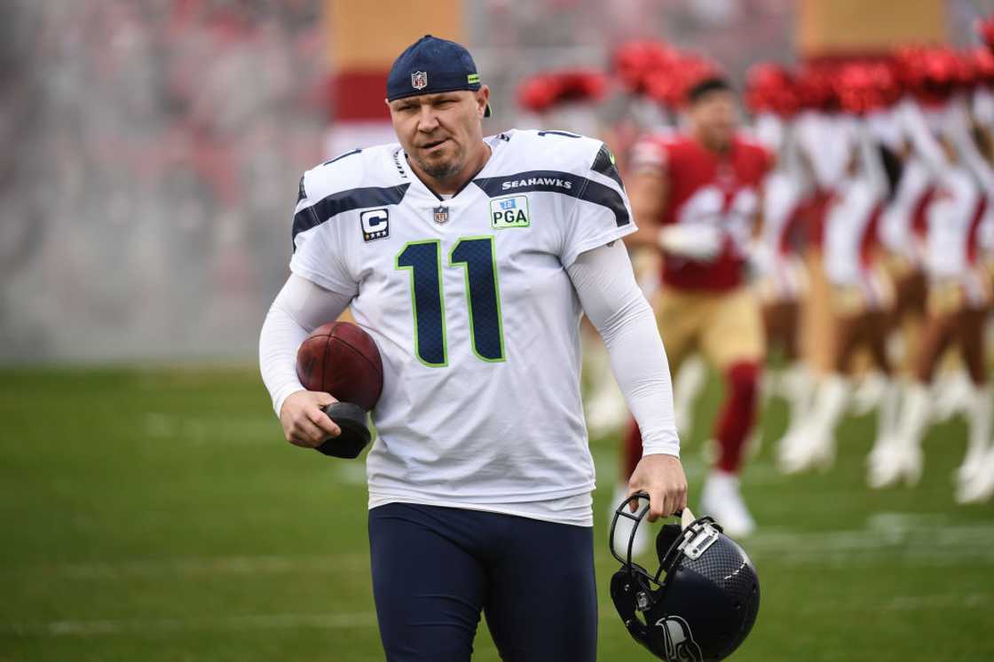 Sebastian Janikowski walks across the pitch before a game