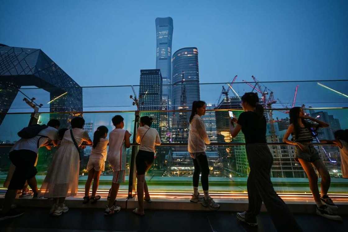 People look at buildings on the skyline from a viewing platform in a mall in Beijing’s central business district People look at buildings on the skyline from a viewing platform in a mall in Beijing’s central business district