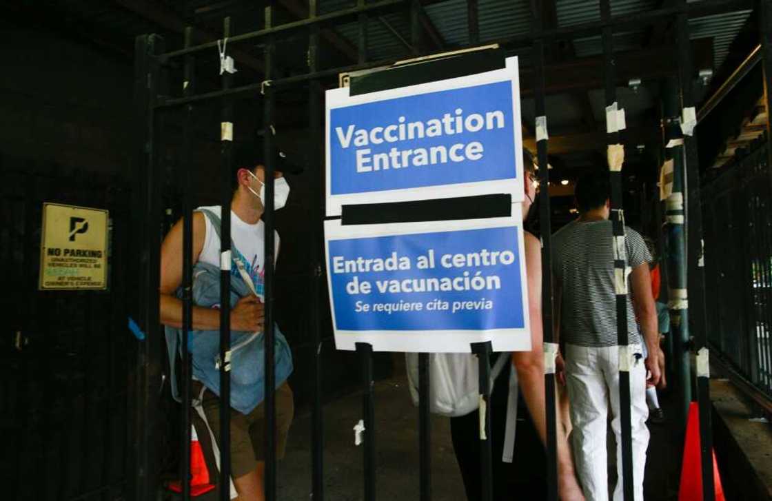 People wait in line to recieve the monkeypox vaccine before the opening of a new mass vaccination site at the Bushwick Education Campus in Brooklyn in New York City