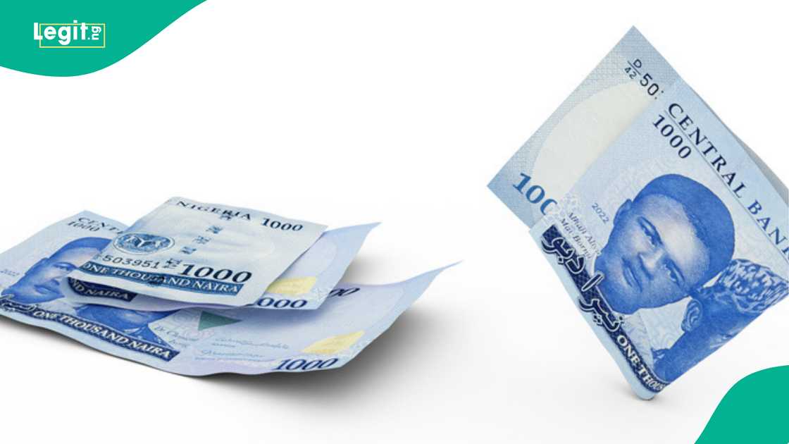 Man shows N1000 note given to conductor by a passenger. Man shows N1000 note given to conductor by a passenger.