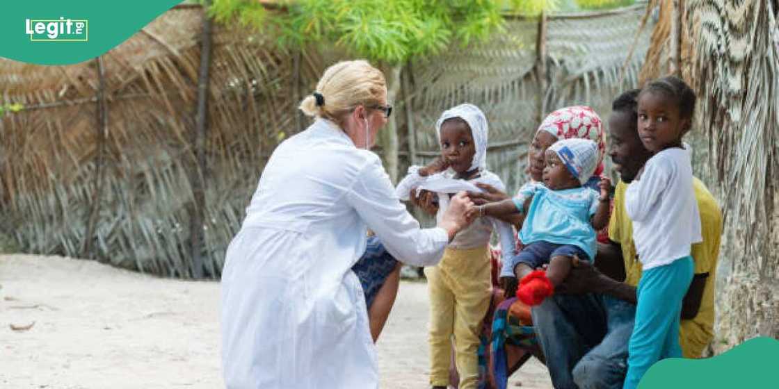 Health practitioner attends to ailing children in Africa Health practitioner attends to ailing children in Africa
