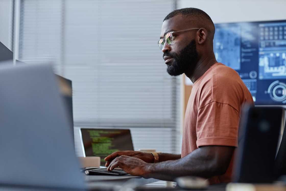 A developer using a computer in a high-tech office.