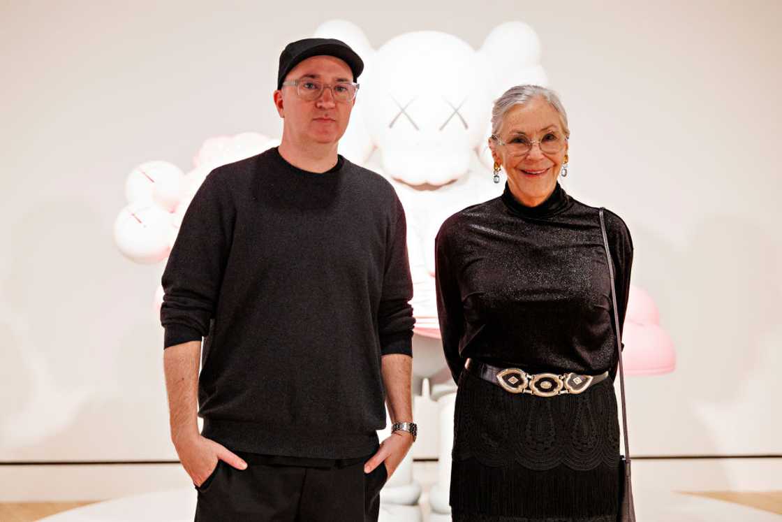 KAWS and Alice Walton pose for photos at the KAWS Director Reception
