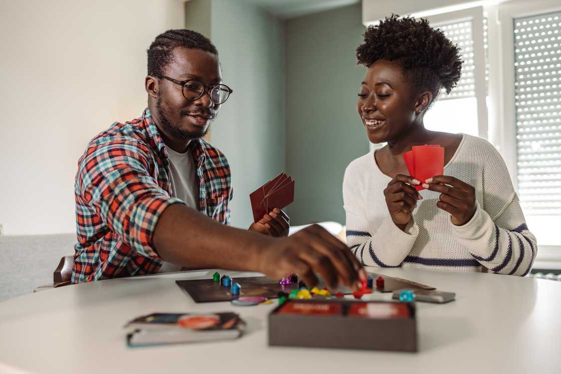 A young couple playing card games A young couple playing card games