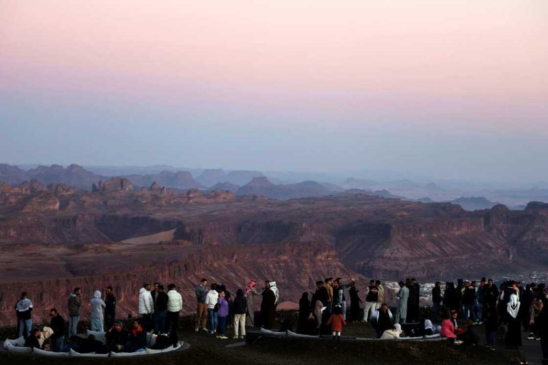 Tourists enjoy panoramic views of the ancient Saudi oasis city of Al-Ula, among a growing number who have beaten a path to the kingdom since it began issuing general tourism visas in 2019