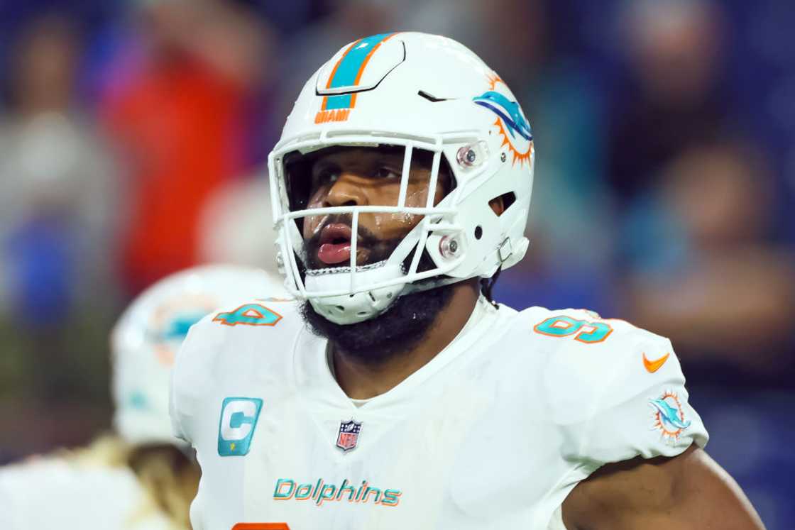 Christian Wilkins runs off the field before an NFL football game Christian Wilkins runs off the field before an NFL football game