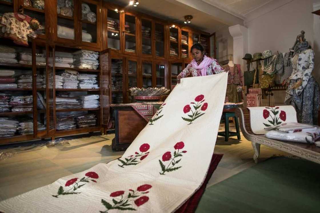 Singh has six employees at her workshop who work on pieces of cloth laid out on tables five metres (16 feet) long Singh has six employees at her workshop who work on pieces of cloth laid out on tables five metres (16 feet) long
