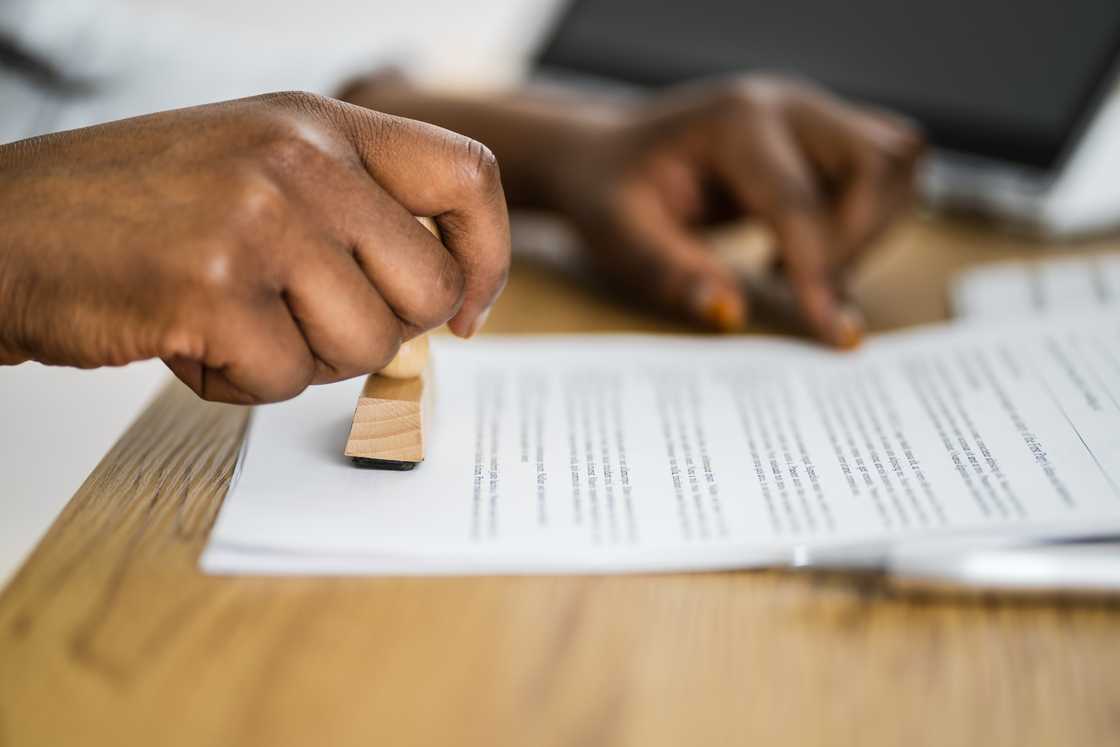 A person stamping application documents A person stamping application documents