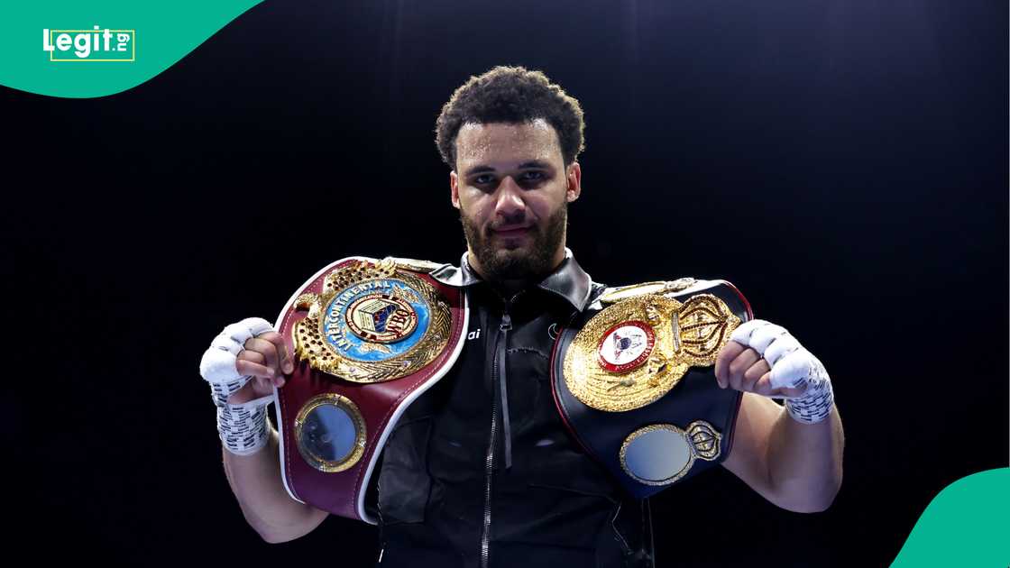 Moses Itauma celebrates victory with his title belts after defeating Jermaine Franklin Jr during the EBU European and WBO Inter-Continental Featherweight Titles. Photo by Alex Livesey
