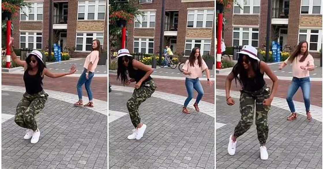 Oyinbo woman dances with black lady, camo trousers Oyinbo woman dances with black lady, camo trousers