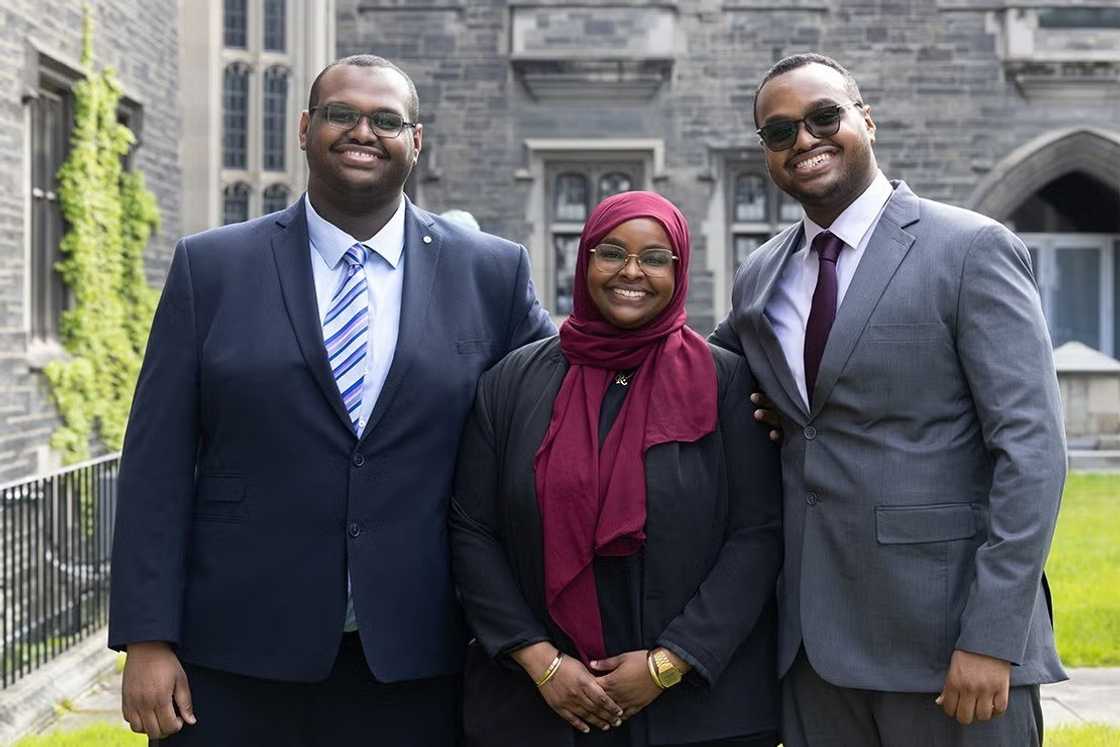 Three University of Toronto graduates posing for a photo
