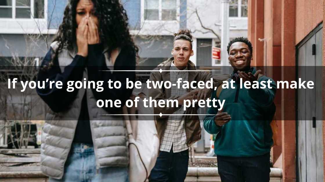 A woman walking away seemingly hurt as two men behind her laugh while pointing at her A woman walking away seemingly hurt as two men behind her laugh while pointing at her