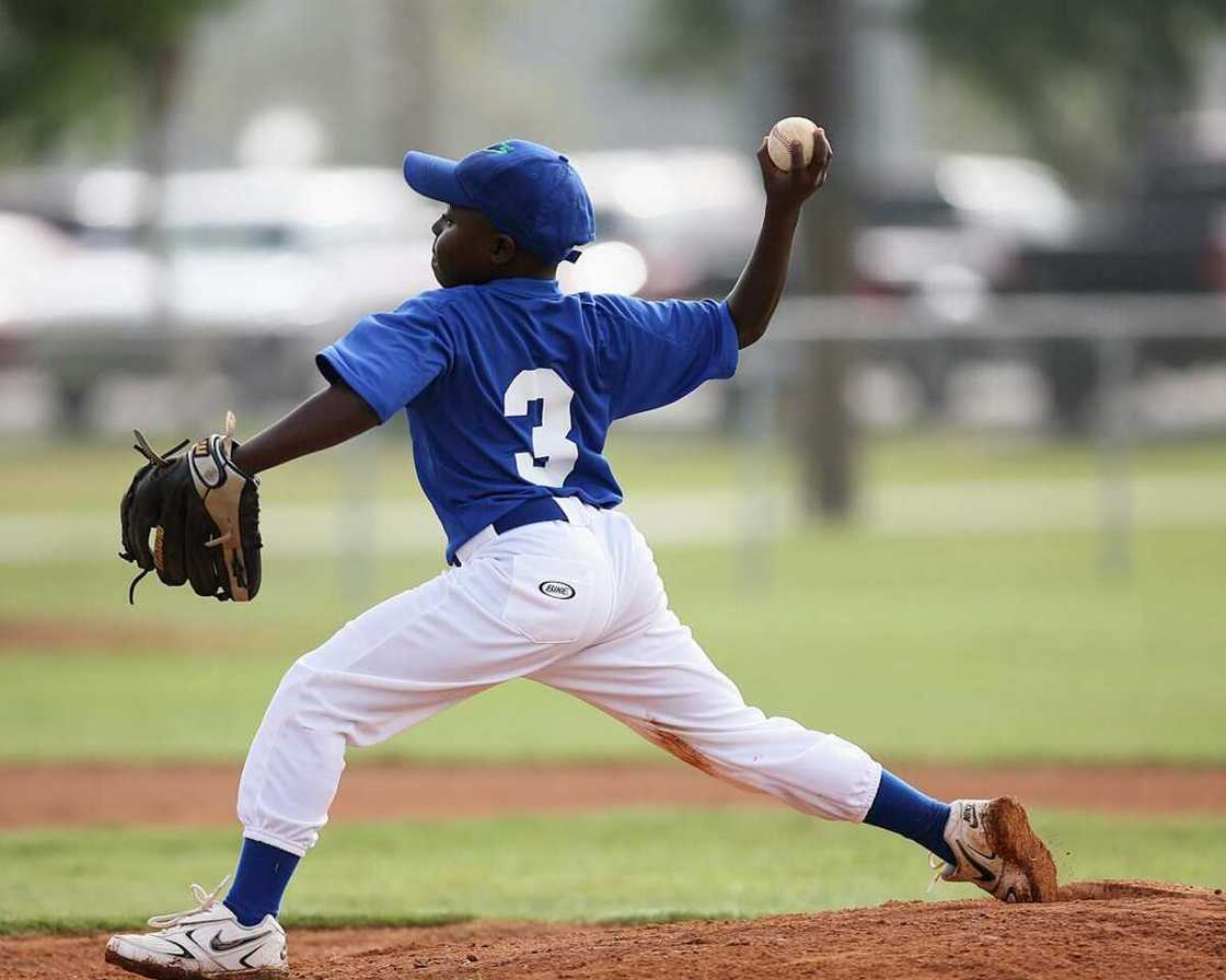 A young boy playing softball