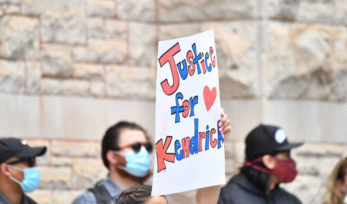 Protesters hold up signs during the Justice For Kendrick Johnson Rally Protesters hold up signs during the Justice For Kendrick Johnson Rally