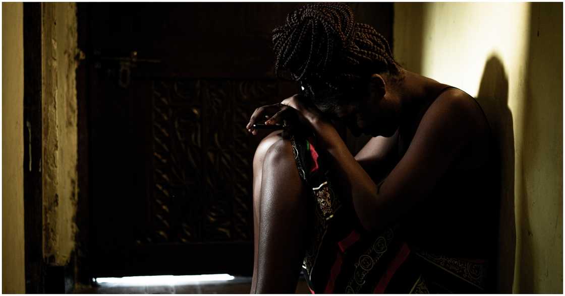 A sad lady is sitting on the floor A sad lady is sitting on the floor