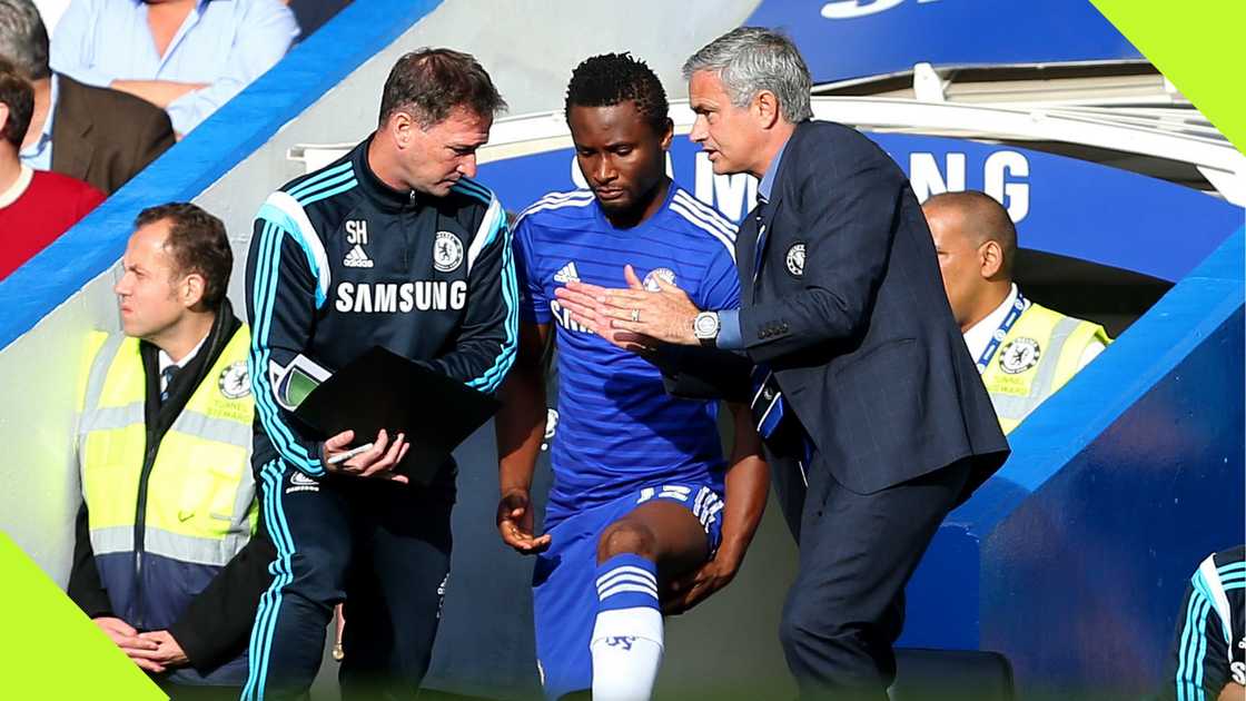 Jose Mourinho and Steve Holland passing instructions to Mikel Obi.