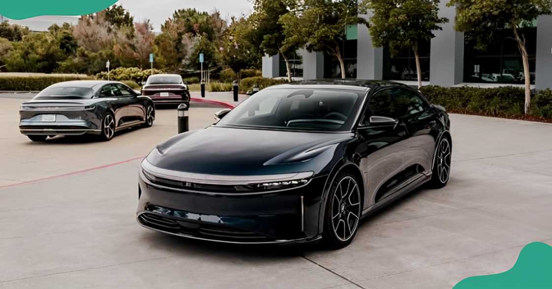 A black Lucid Air Sapphire parked in front of a building. A black Lucid Air Sapphire parked in front of a building.