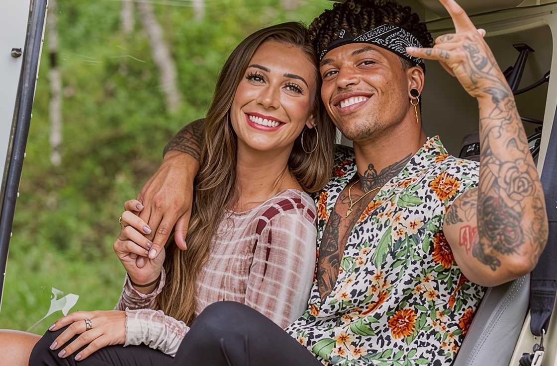 Olivia Kaiser and Korey Gandy hold each other while sitting in a golf cart