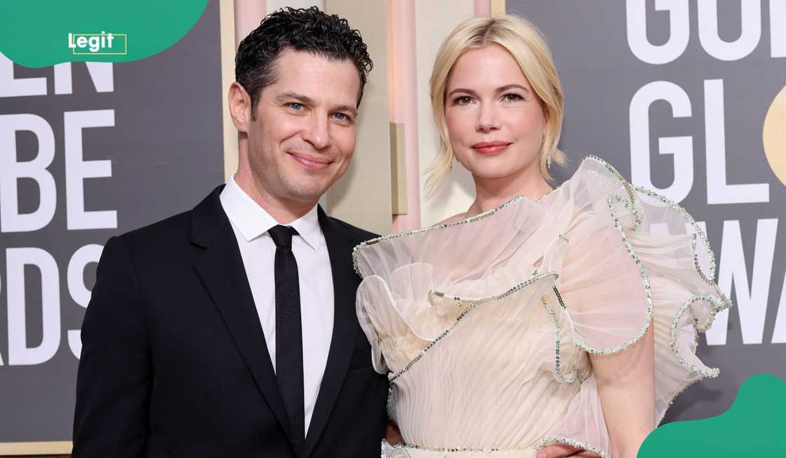 Thomas Kail and Michelle Williams pose on the red carpet of the Golden Globe Awards