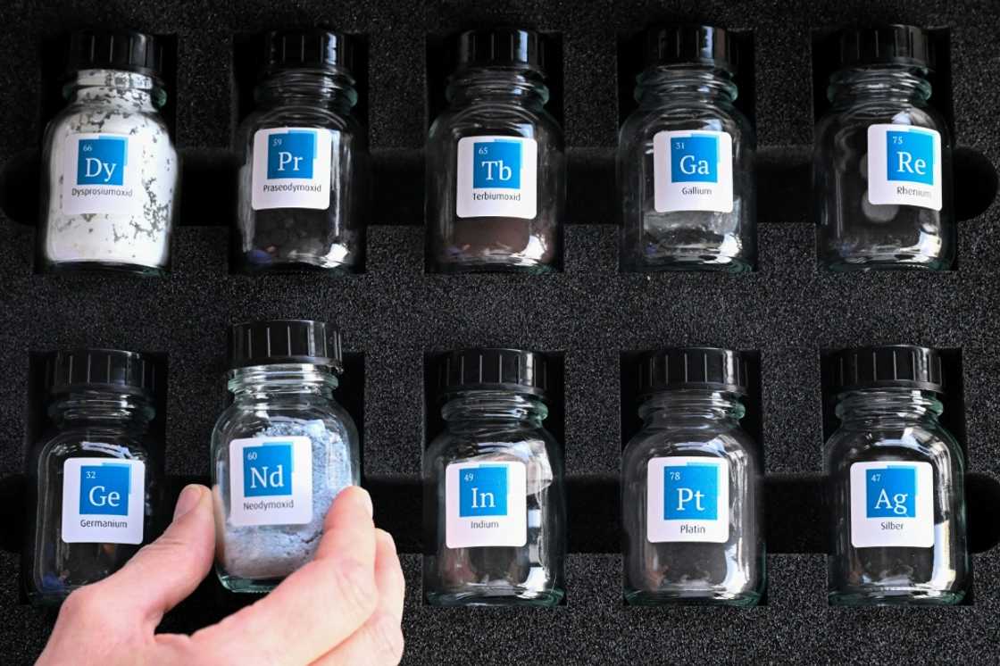 Glass jars containing samples of rare earths are pictured inside the storage room of Tradium