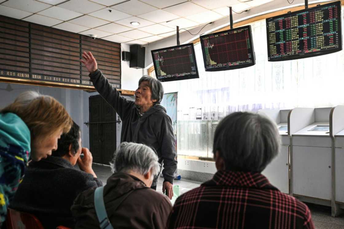 Investors monitor stock price movements at a securities company in Shanghai Investors monitor stock price movements at a securities company in Shanghai