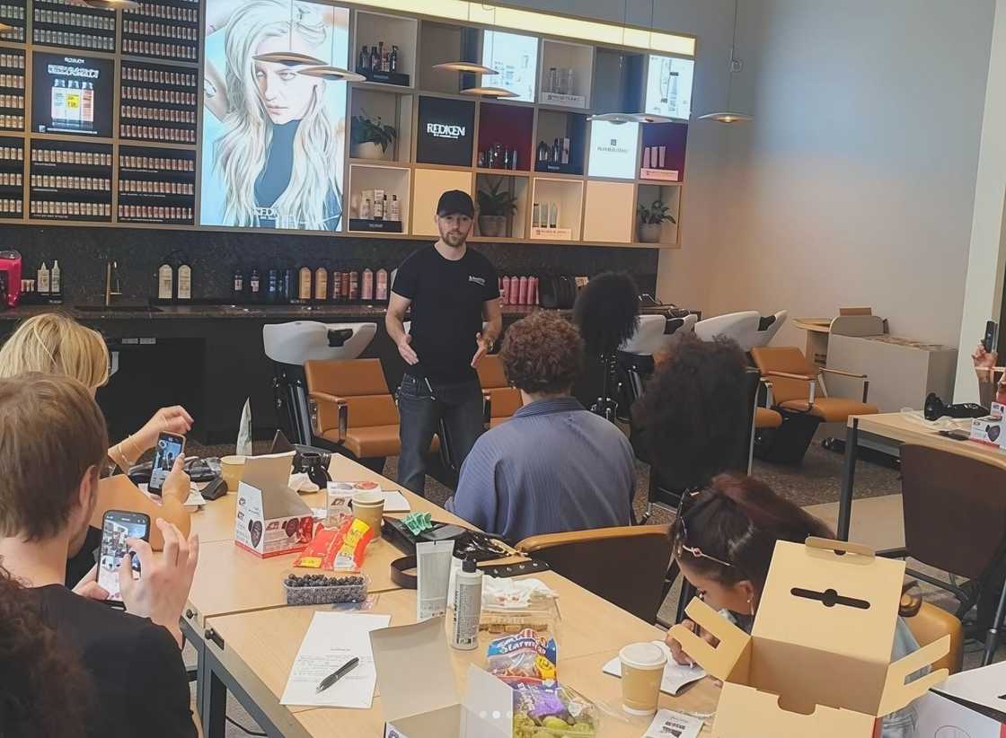 Rory McPhee demonstrates during a hairdressing class