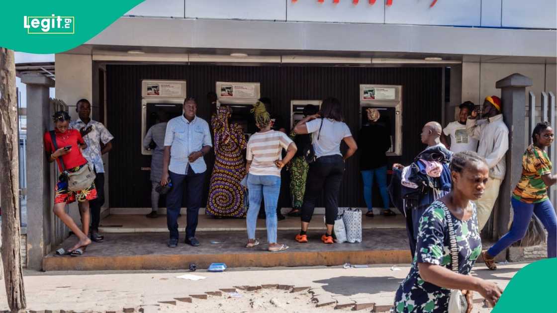 Nigerians withdrawing cash in a bank's ATM stand. Nigerians withdrawing cash in a bank's ATM stand.