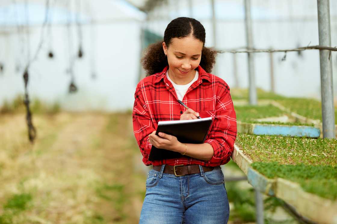 A female farmer writing down notes
