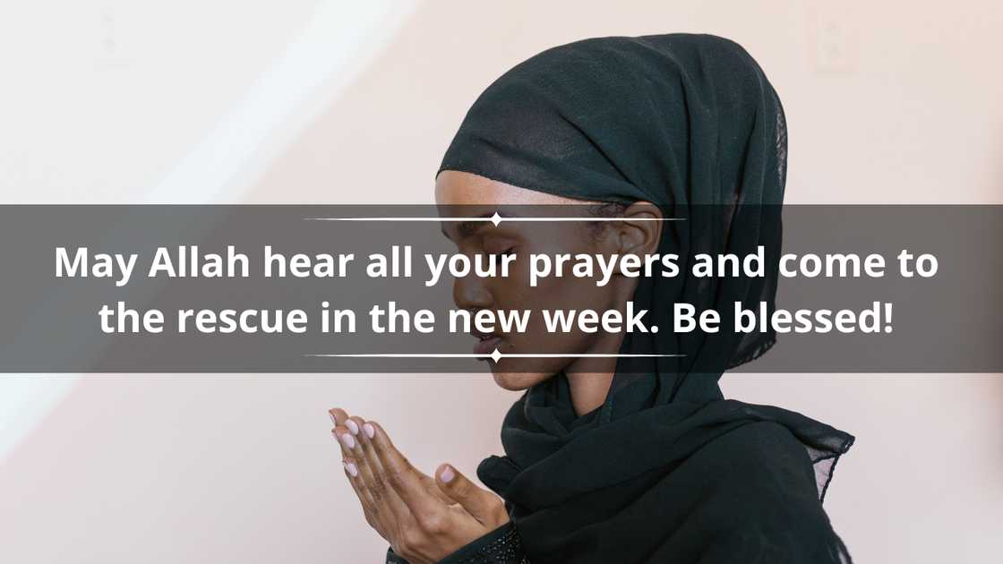 A woman in a black hijab praying