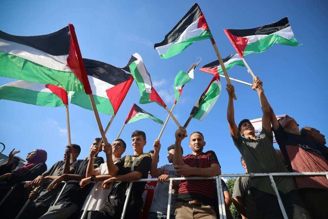 US President Joe Biden's visit has sparked strong reactions: here Palestinian demonstrators wave flags as they gather to protest against it in Gaza City on July 14