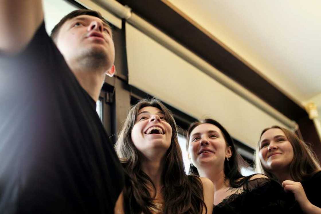 Ukrainian students (L-R) Roman Koval, Karyna Myshnova, Anna Fursyk and Alina Kuprii take a selfie during an interview with AFP at Tunghai University in Taichung, Taiwan Ukrainian students (L-R) Roman Koval, Karyna Myshnova, Anna Fursyk and Alina Kuprii take a selfie during an interview with AFP at Tunghai University in Taichung, Taiwan