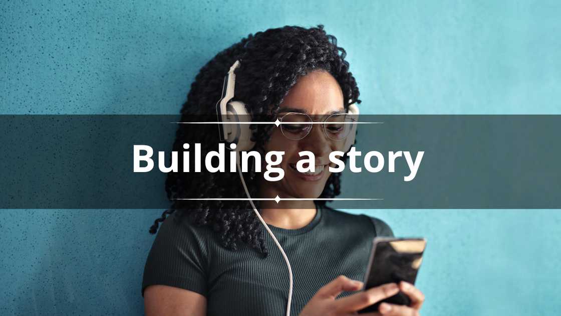 A happy woman in a green top leaning on a blue wall A happy woman in a green top leaning on a blue wall