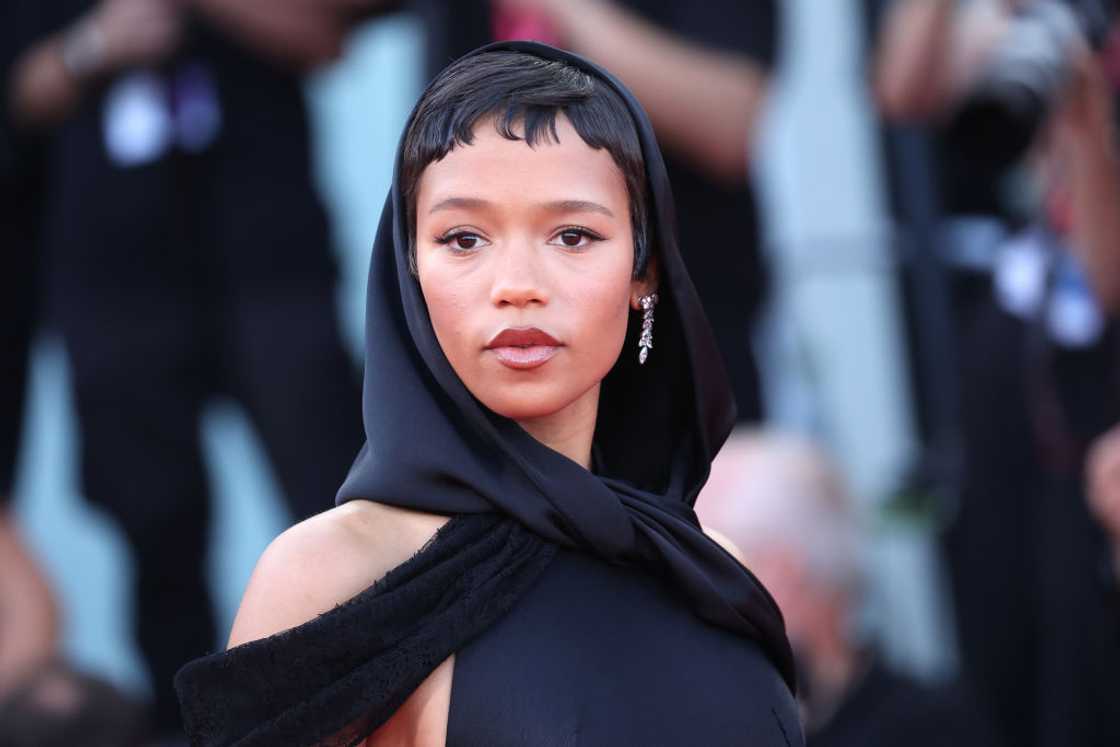 Taylor Russell poses in black at the 81st Venice International Film Festival